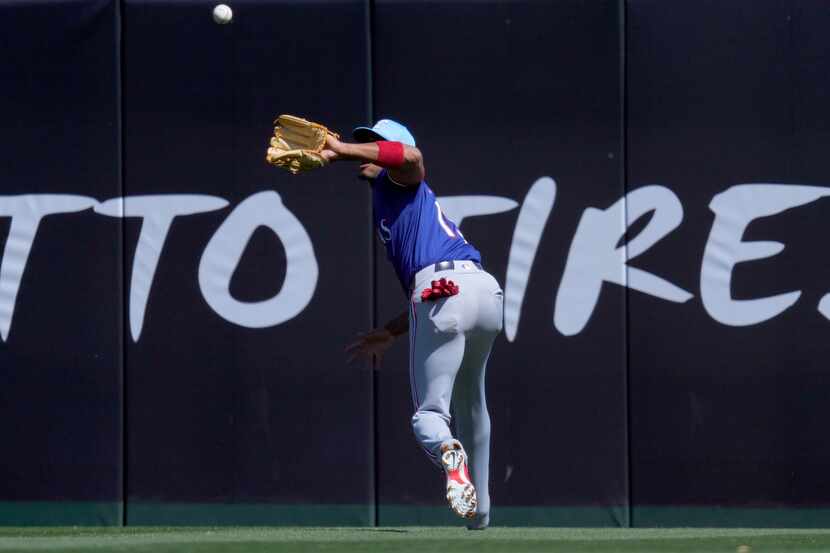 Texas Rangers' Jose Barrero fields a fly out hit by Los Angeles Angels' Logan O'Hoppe during...