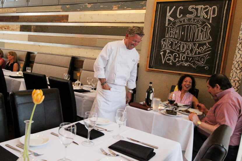 Chef Tim Love, left, chatted with Ed and Rozann Juth as they enjoyed their dinner Friday...