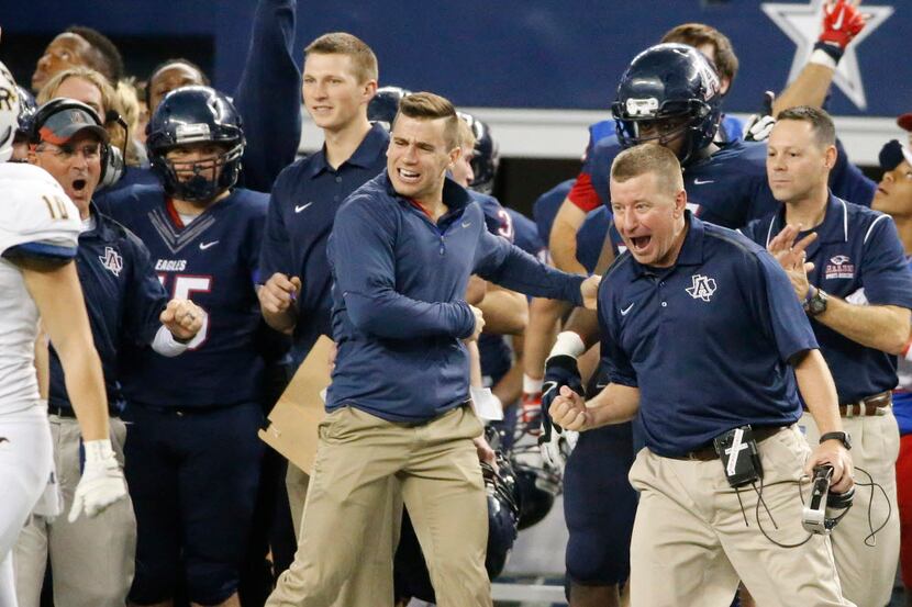 Allen head coach Tom Westerberg, right, celebrates with his assistant coaches as Allen...