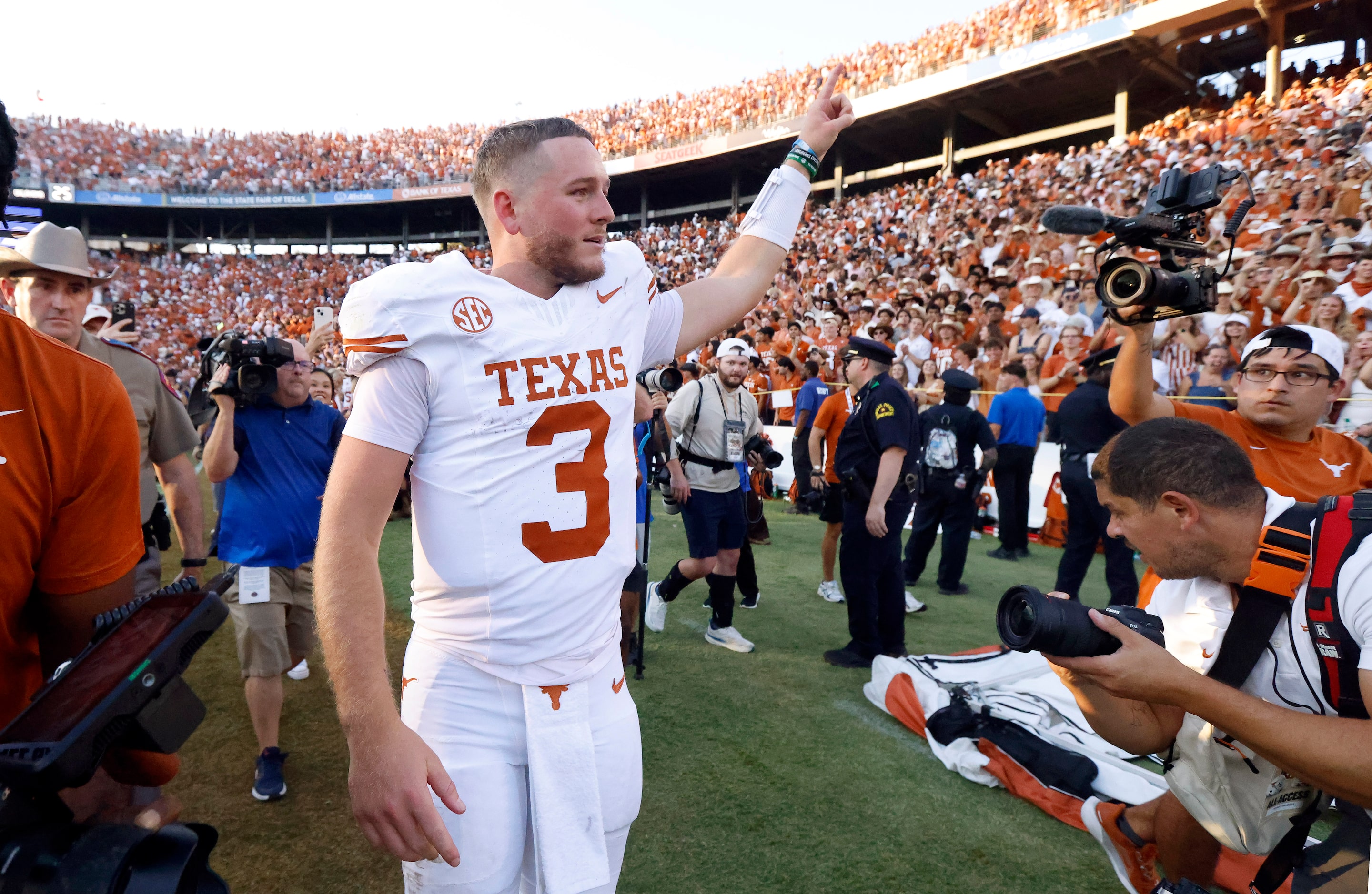 Texas Longhorns quarterback Quinn Ewers (3) flashes the horns sign following their Red River...