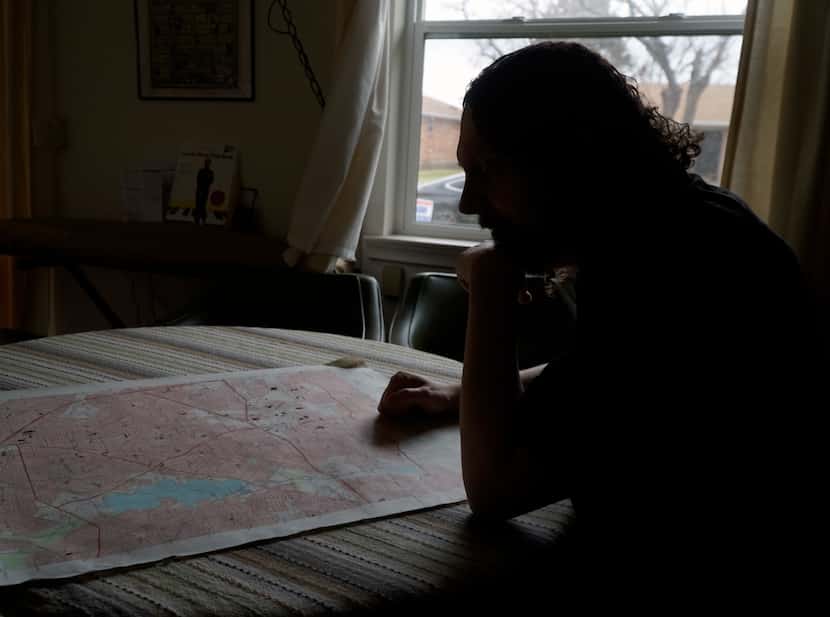 Milazzo looks over a topographic map at his home. “We’re out there in the field, looking for...