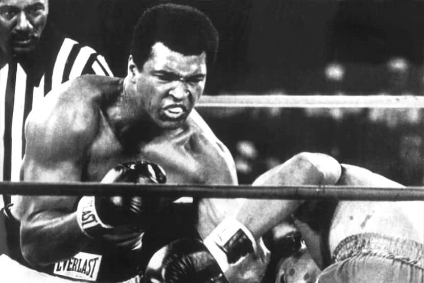 Boxer Muhammad Ali (left) reclaimed his heavyweight world championship title by knocking out...
