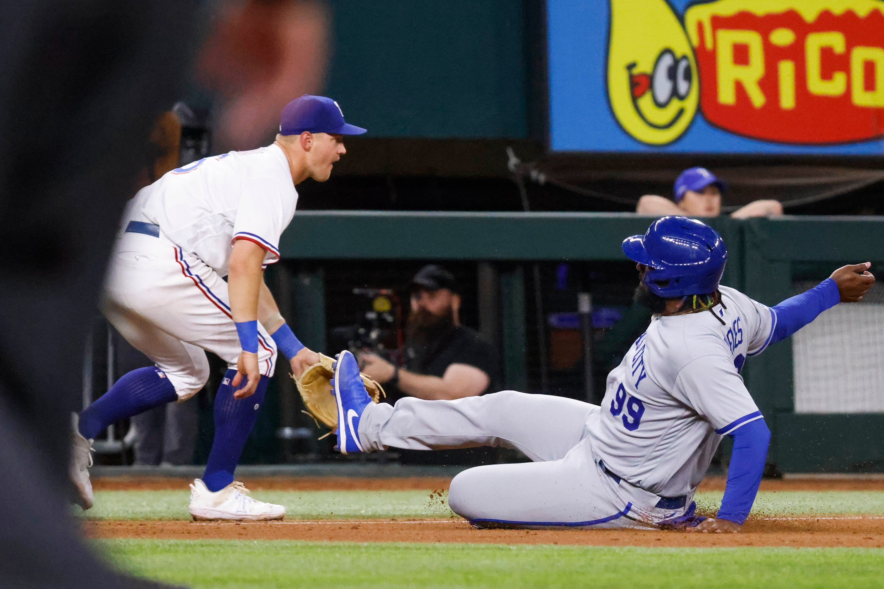 Kansas City Royals right fielder Franmil Reyes (right) advances to the third base past Texas...