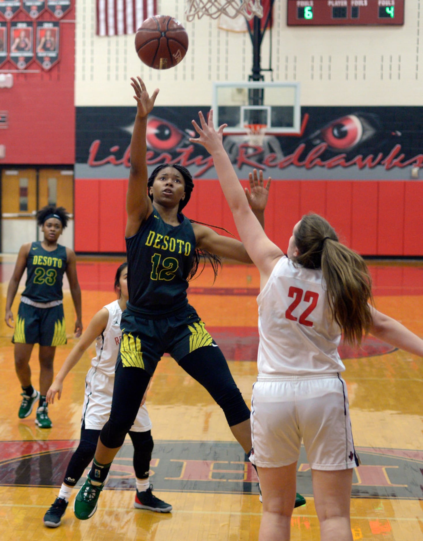 DeSoto's Jiya Perry (12) shoots over Libert's Kyla Crawford (22) in the first half during a...