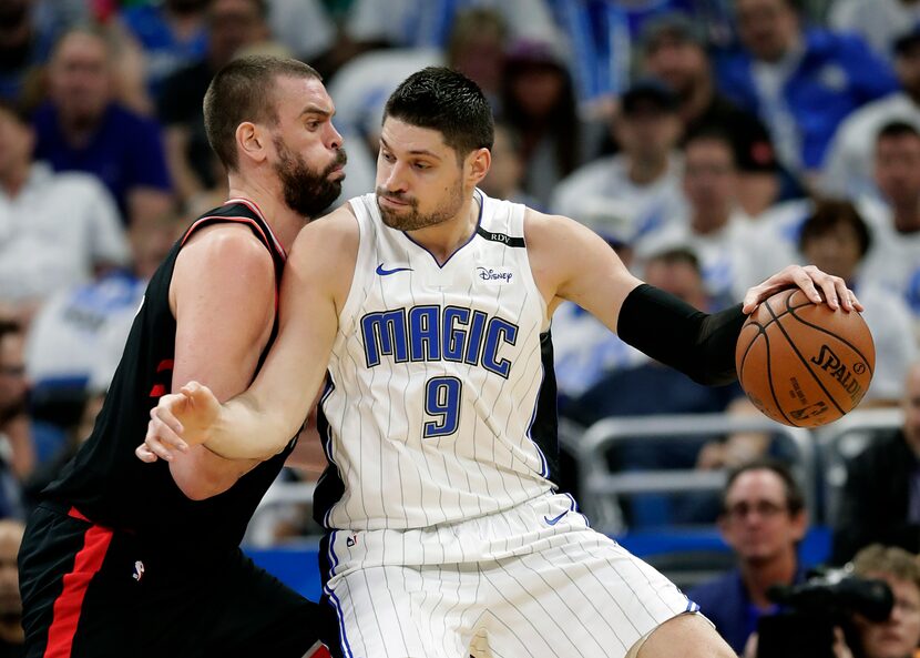 Orlando Magic's Nikola Vucevic (9) tries to get past Toronto Raptors' Marc Gasol during the...