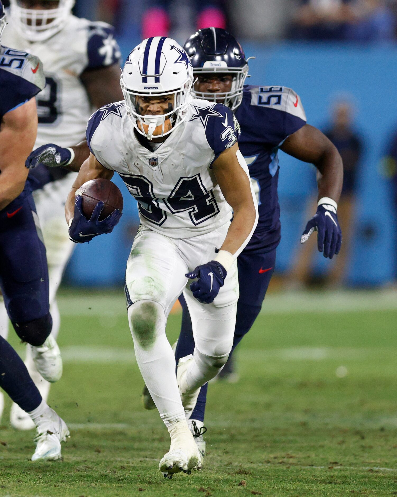 Dallas Cowboys running back Malik Davis (34) runs for a first down ahead of Tennessee Titans...