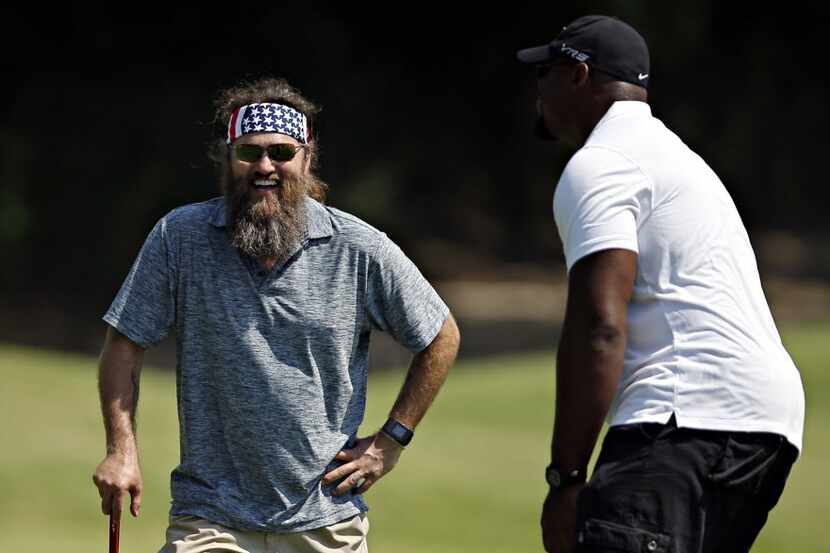 Duck Dynasty star Willie Robertson (left) laughs as he and Dallas Cowboys tackle Tyron Smith...