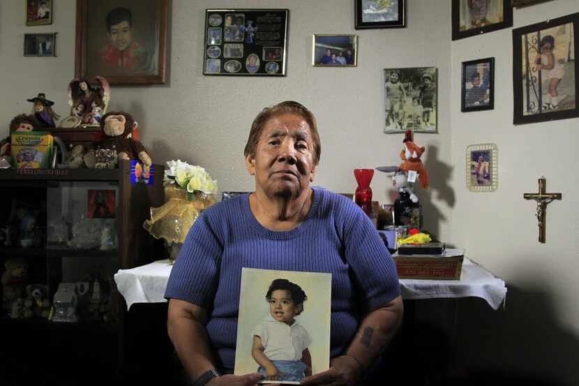 Bessie Rodriguez, the mother of Santos Rodriguez, holds a painting of her son in her Dallas...