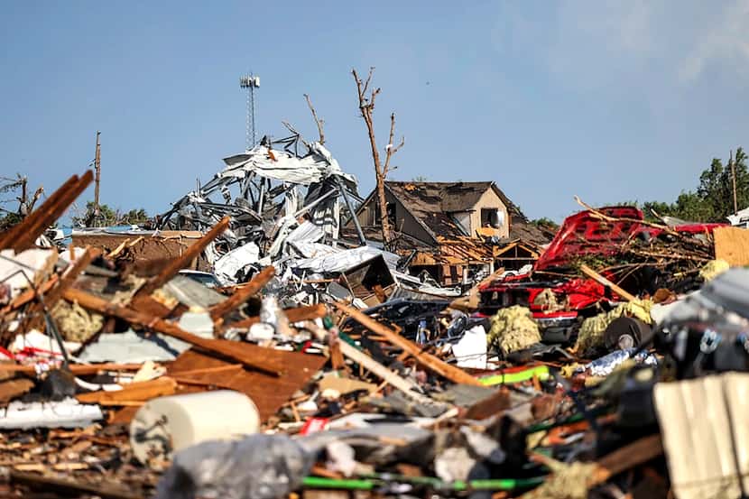 Debris covers a residential area in Perryton, Texas, Thursday, June 15, 2023, after a...
