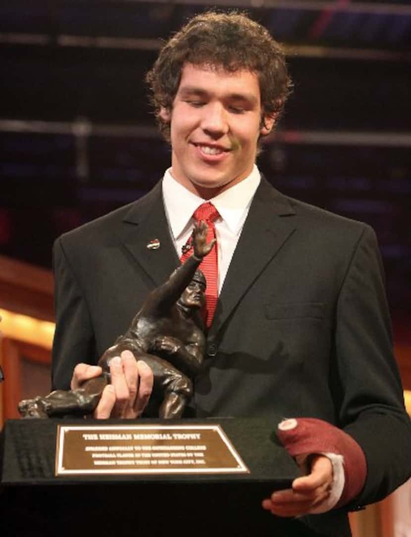 ORG XMIT: *S0425141869* Oklahoma football player Sam Bradford holds the Heisman Trophy after...