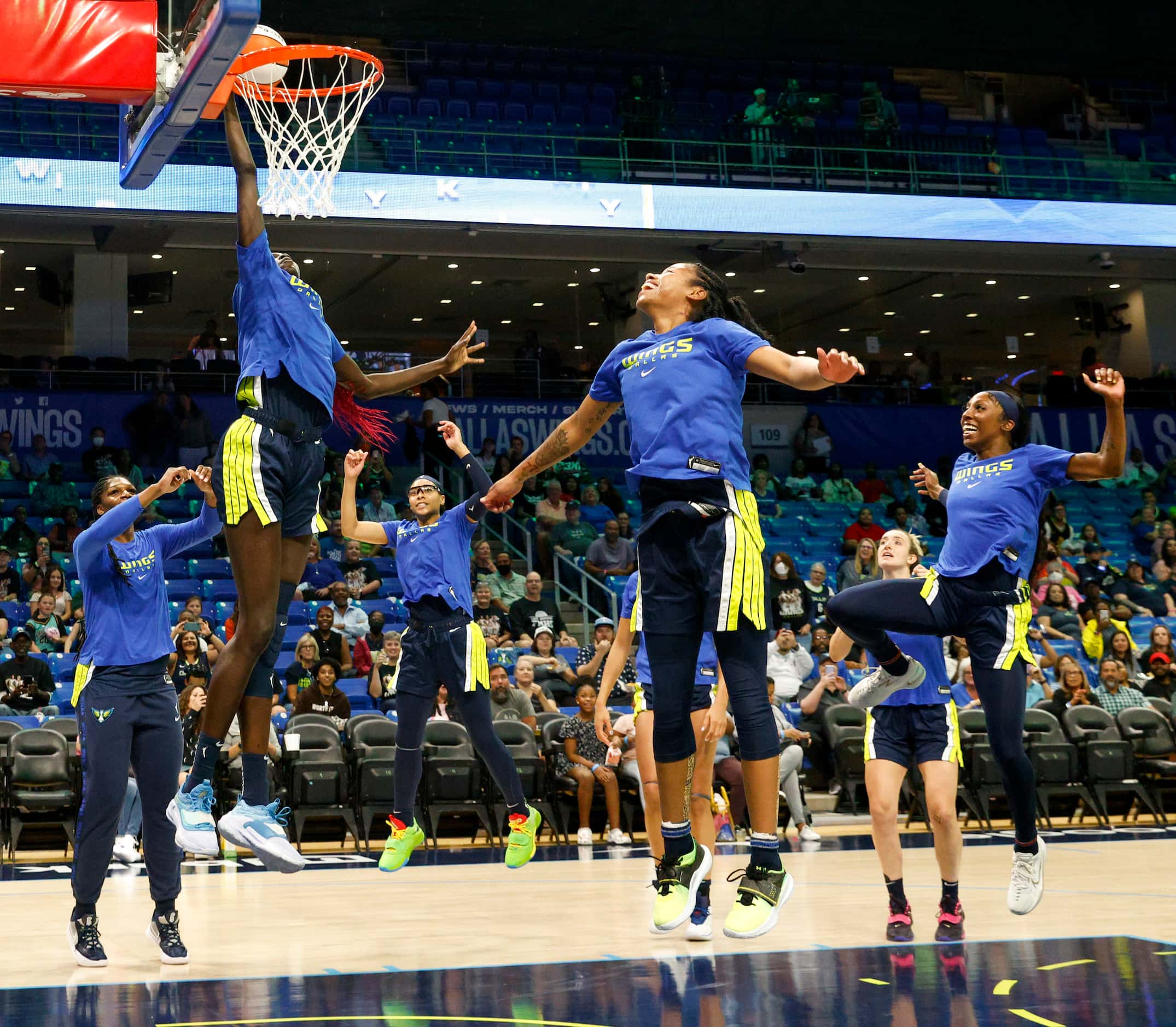 Dallas Wings center Awak Kuier (28) dunks the ball as part of a team ritual before a game...