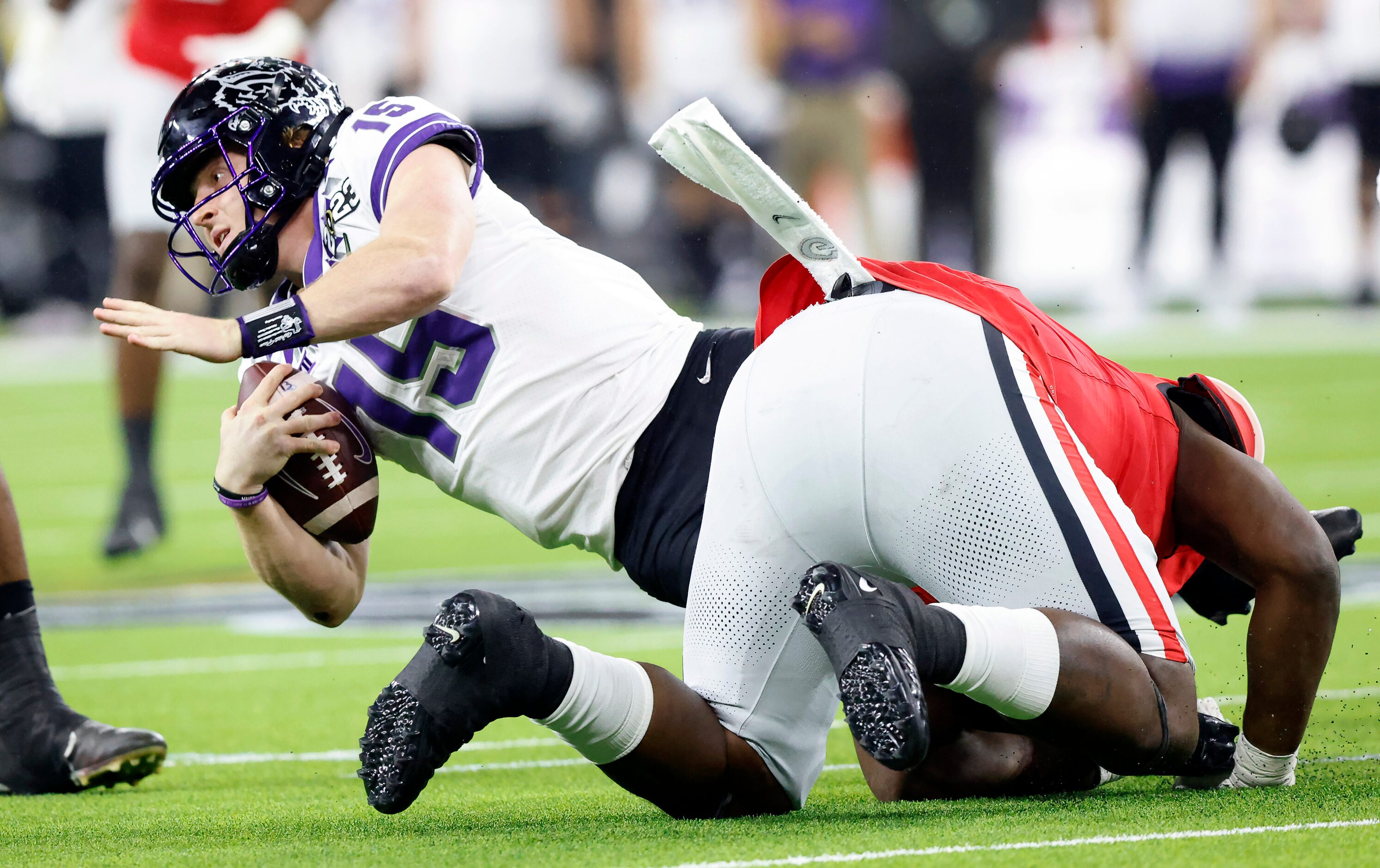 TCU Horned Frogs quarterback Max Duggan (15) is sacked by Georgia Bulldogs defensive lineman...