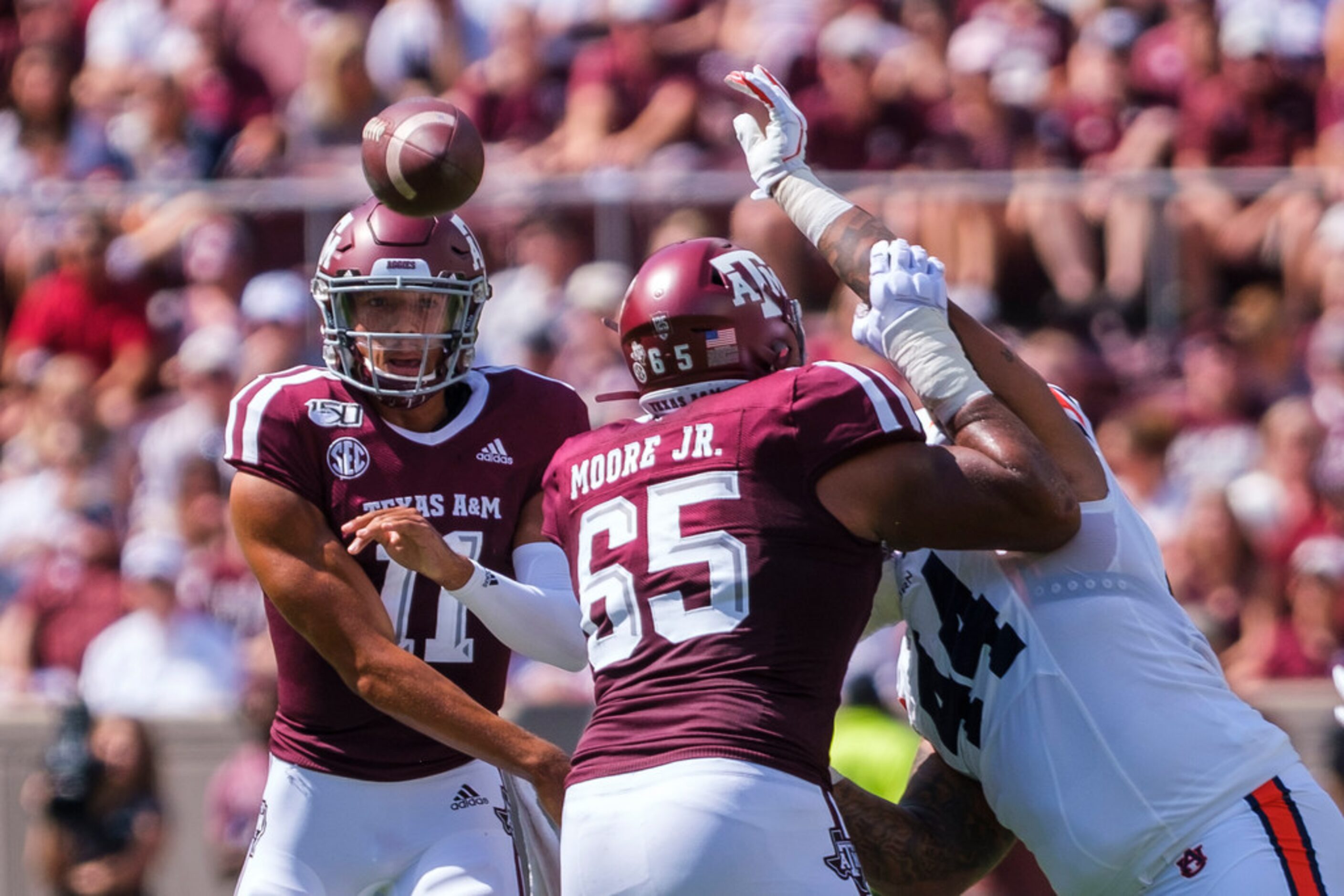 Texas A&M quarterback Kellen Mond (11) gets a block from offensive lineman Dan Moore Jr....