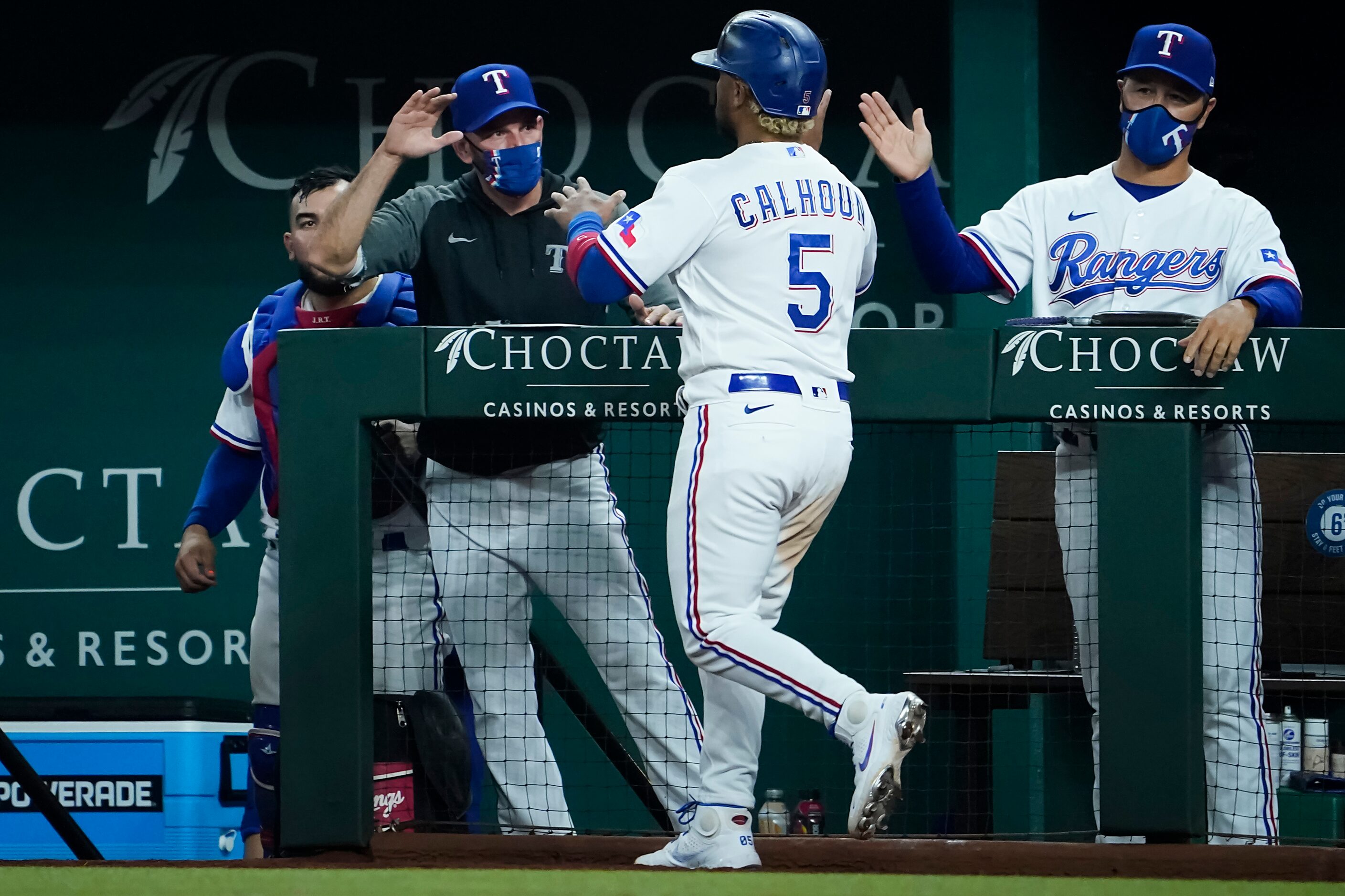 Texas Rangers designated hitter Willie Calhoun celebrates with Texas Rangers manager Chris...