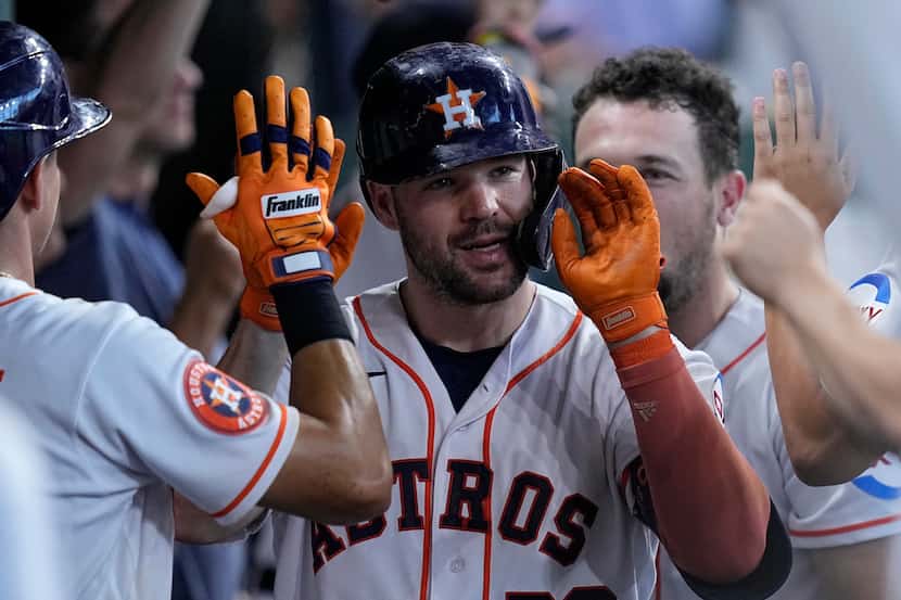 Houston Astros' Chas McCormick is congratulated in the dugout after hitting a two-run home...