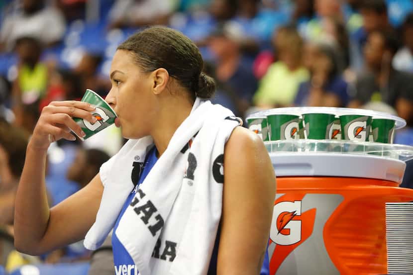 Dallas Wings center Liz Cambage (8) cools off on the team bench during  first half action...