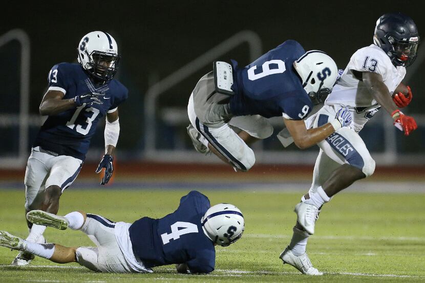 Fort Worth All Saints' Denver Bush (9) attempts to make a tackle on Episcopal School of...