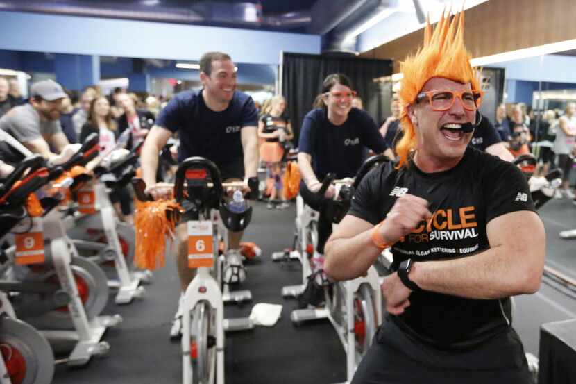 Instructor Will Amason leads a group of cyclist during the Cycle for Survival event at...