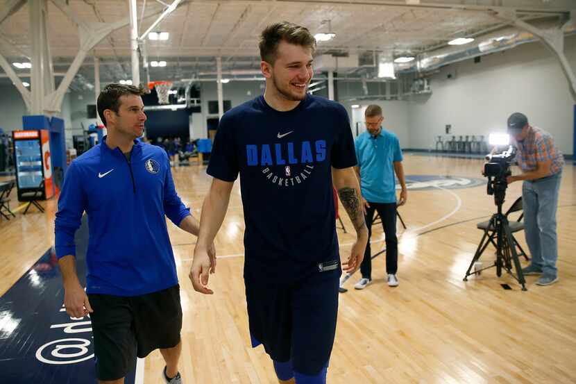 Mavericks guard/forward Luka Doncic walks to a group of the media for an interview after a...