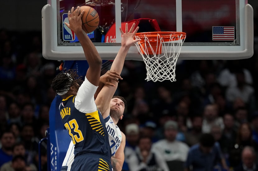 Indiana Pacers center Myles Turner (33) dunks on Dallas Mavericks guard Luka Doncic (77)...