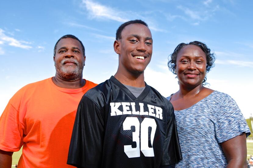 K.L. Norwood, 18, center, poses for a photo with his parents Kemper Norwood Sr. and Linda...