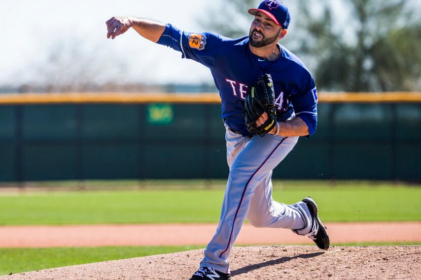 Texas Rangers starting pitcher Dillon Gee (36) pitches during a spring training workout at...