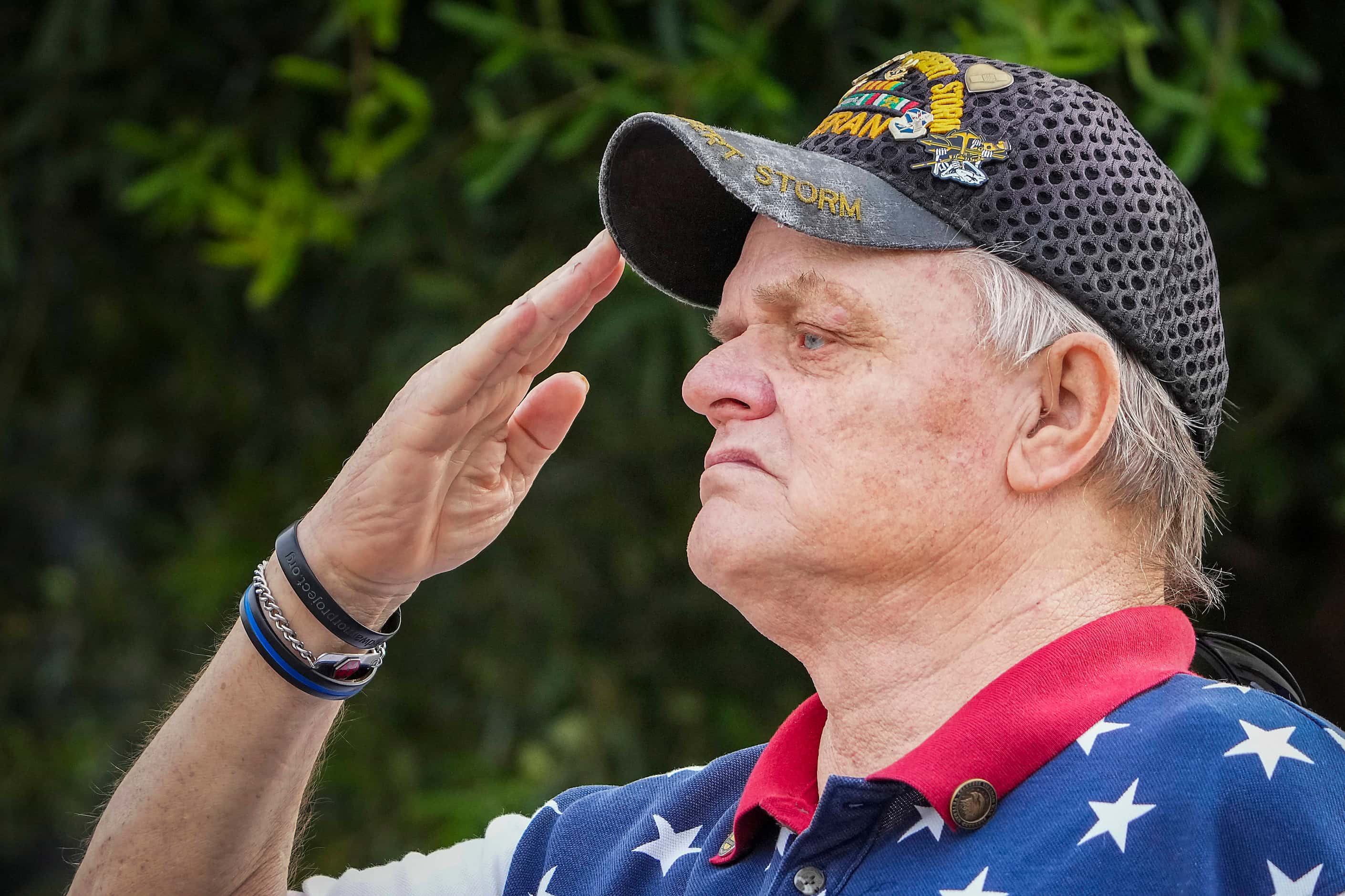 U.S. Air Force veteran Mark James salutes during the playing of the national anthem during...