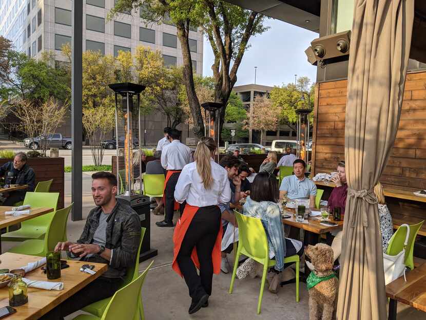 People seated on an outdoor patio at a restaurant