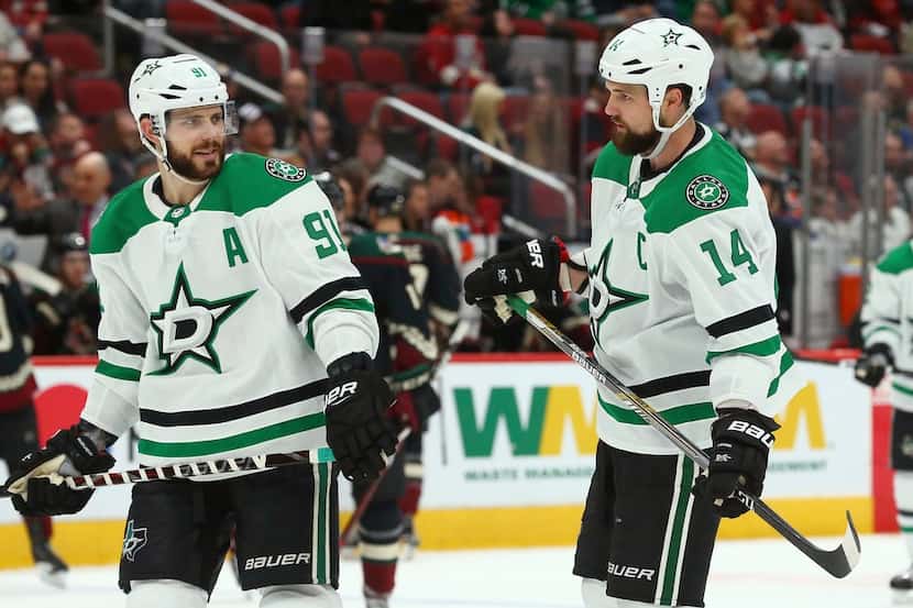 Dallas Stars center Tyler Seguin (91) and left wing Jamie Benn (14) chat on the ice during...
