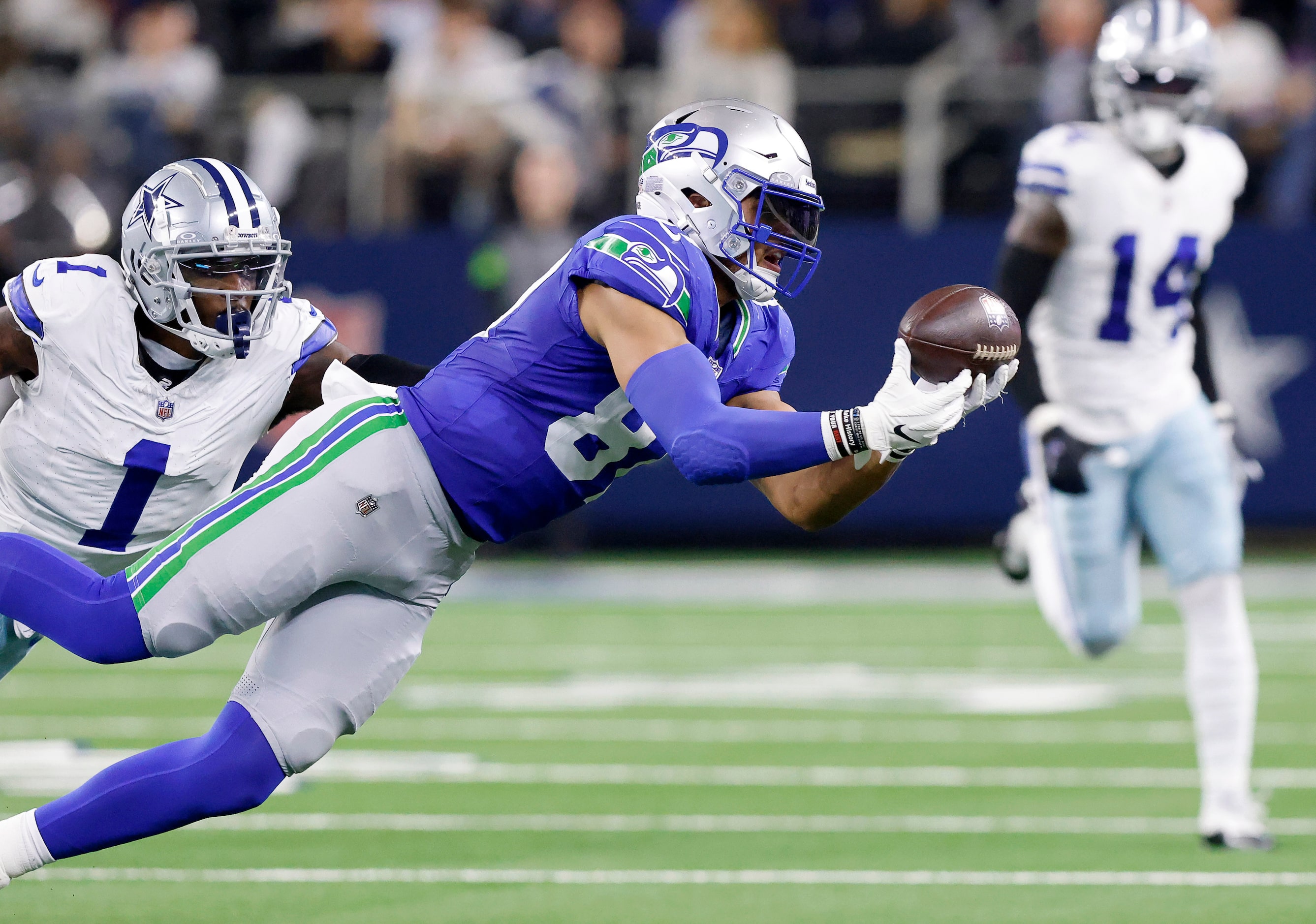 Seattle Seahawks tight end Noah Fant (87) lays out for a third quarter pass completion...