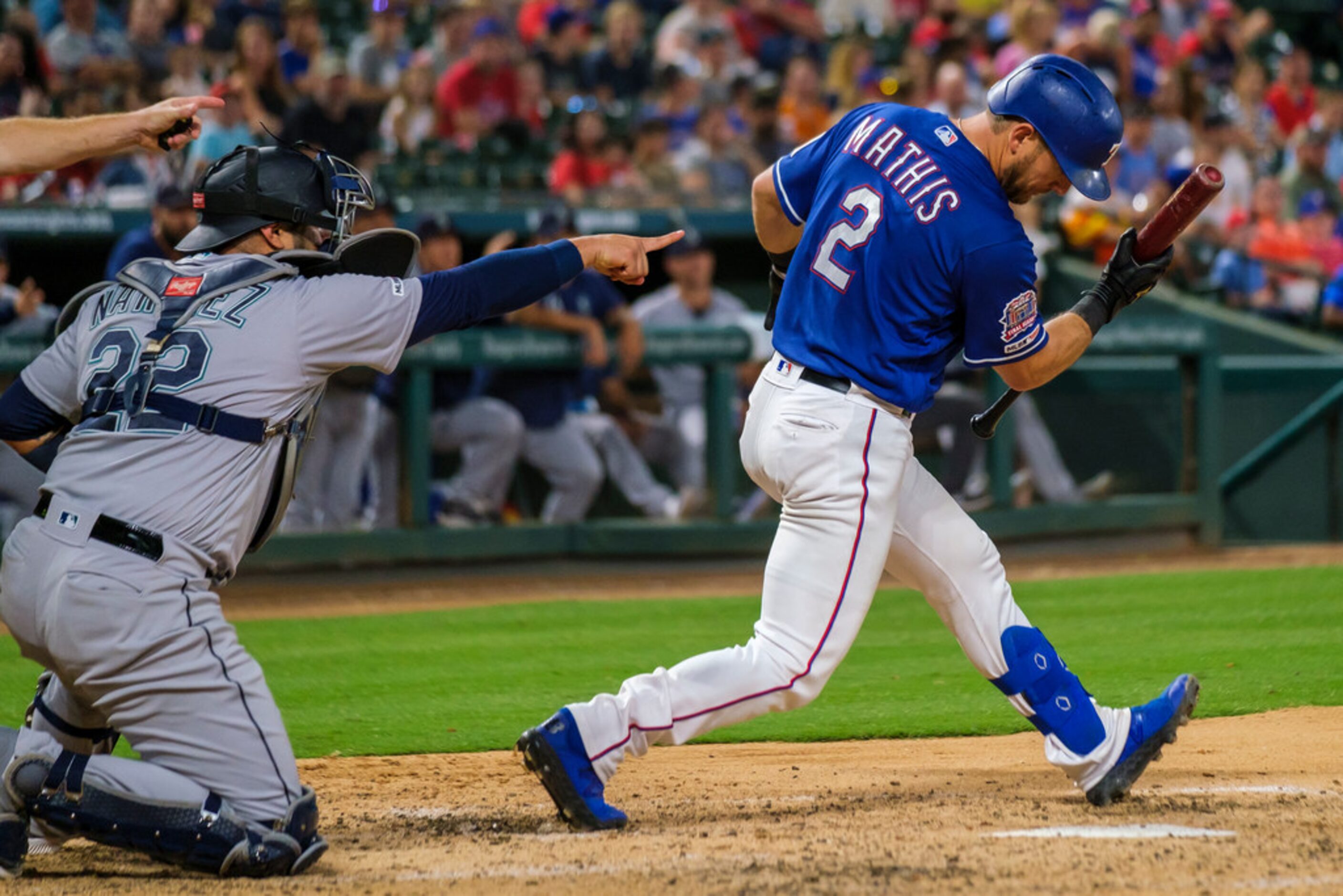 Seattle Mariners catcher Omar Narvaez (22) points as Texas Rangers catcher Jeff Mathis (2)...