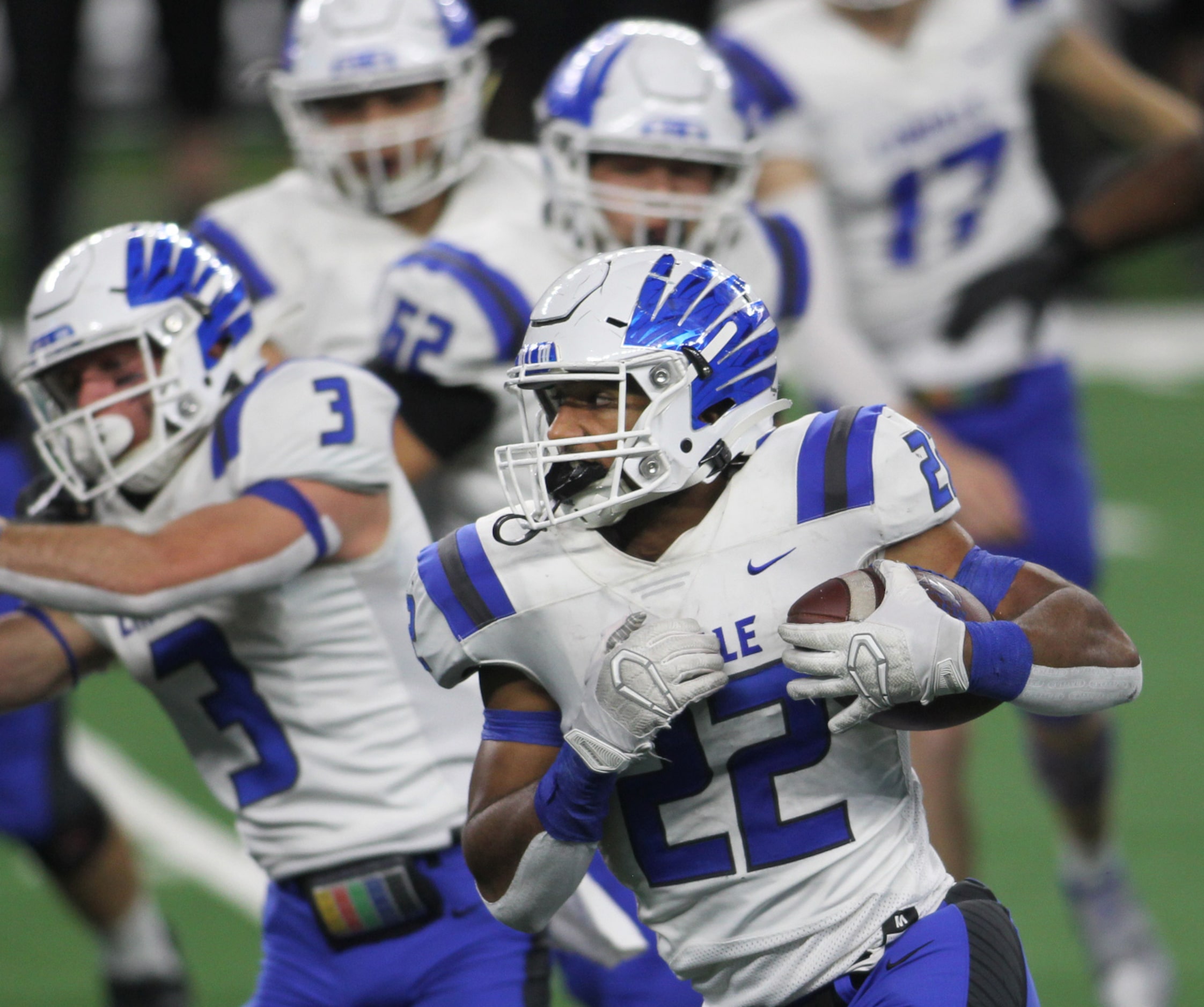 Lindale running back Jordan Jenkins (22) runs in front of a host of blockers during first...