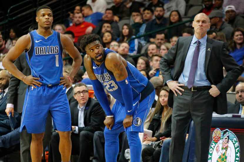 Dallas Mavericks Dennis Smith Jr. (1), Wesley Matthews (23) and head coach Rick Carlisle are...