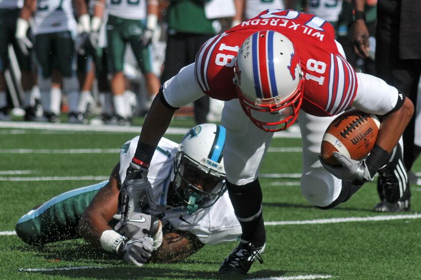 SMU wide receiver Terrance Wilkerson (18) tries to keep his balance after a hit from Tulane...