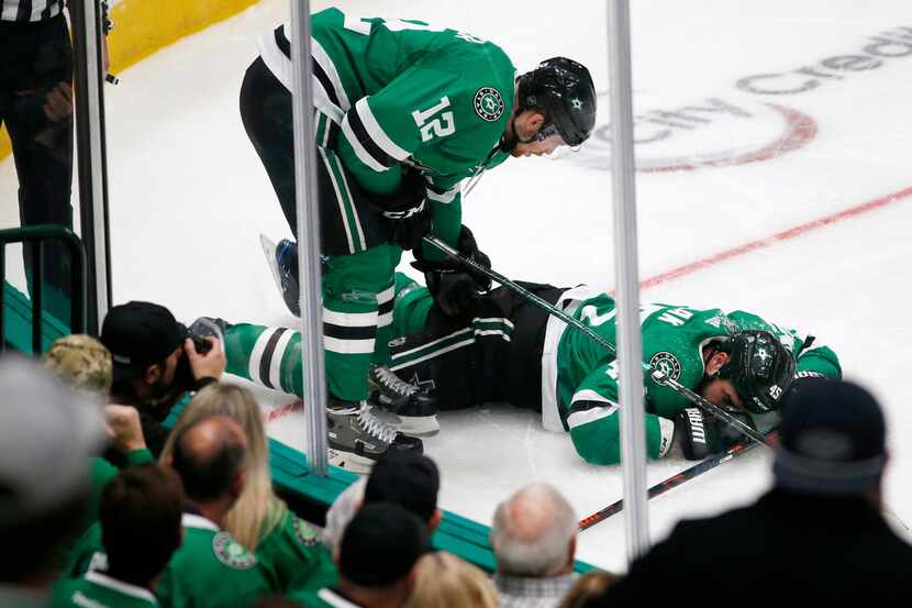 Dallas Stars center Radek Faksa (12) checks on injured player Dallas Stars defenseman Roman...