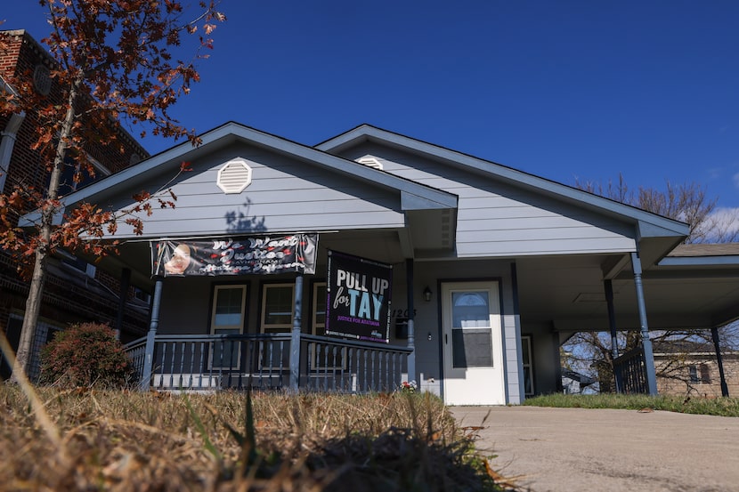 Banners hang from the house where Atatiana Jefferson was killed in Fort Worth on Tuesday,...