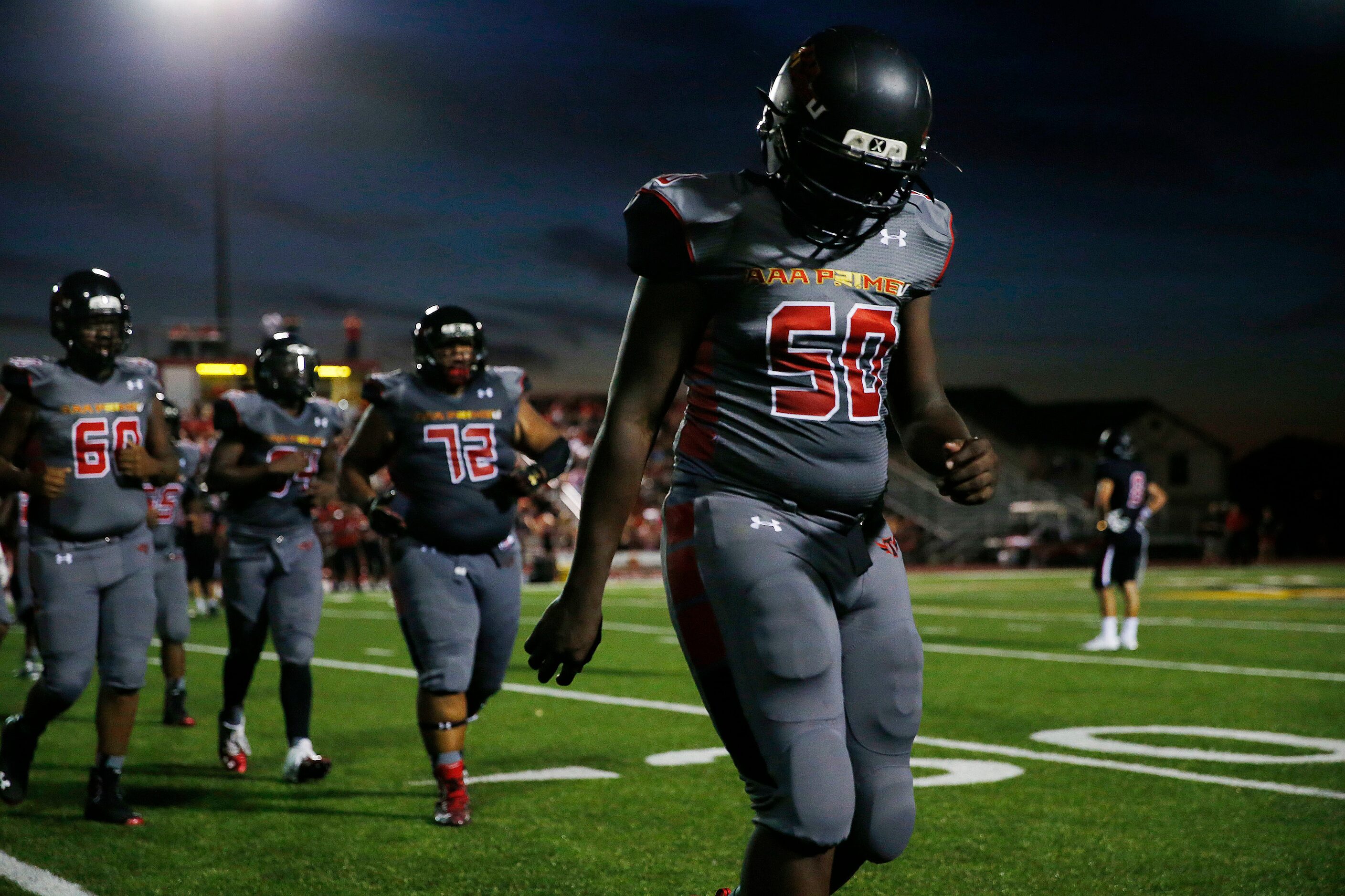 AAA Prime U player Chauncey Brown walks off the field with teammates in the first half...