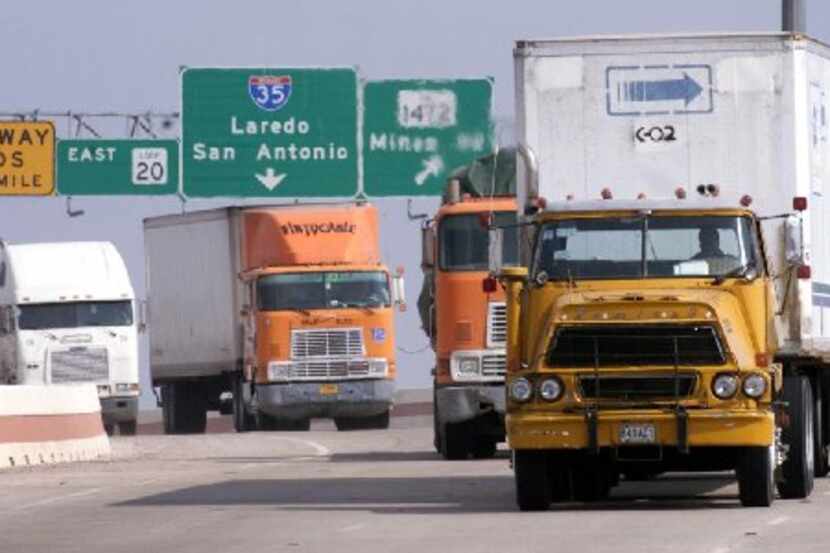 
Mexican, American and Canadian trucks head to the World Trade Bridge in Laredo on their way...