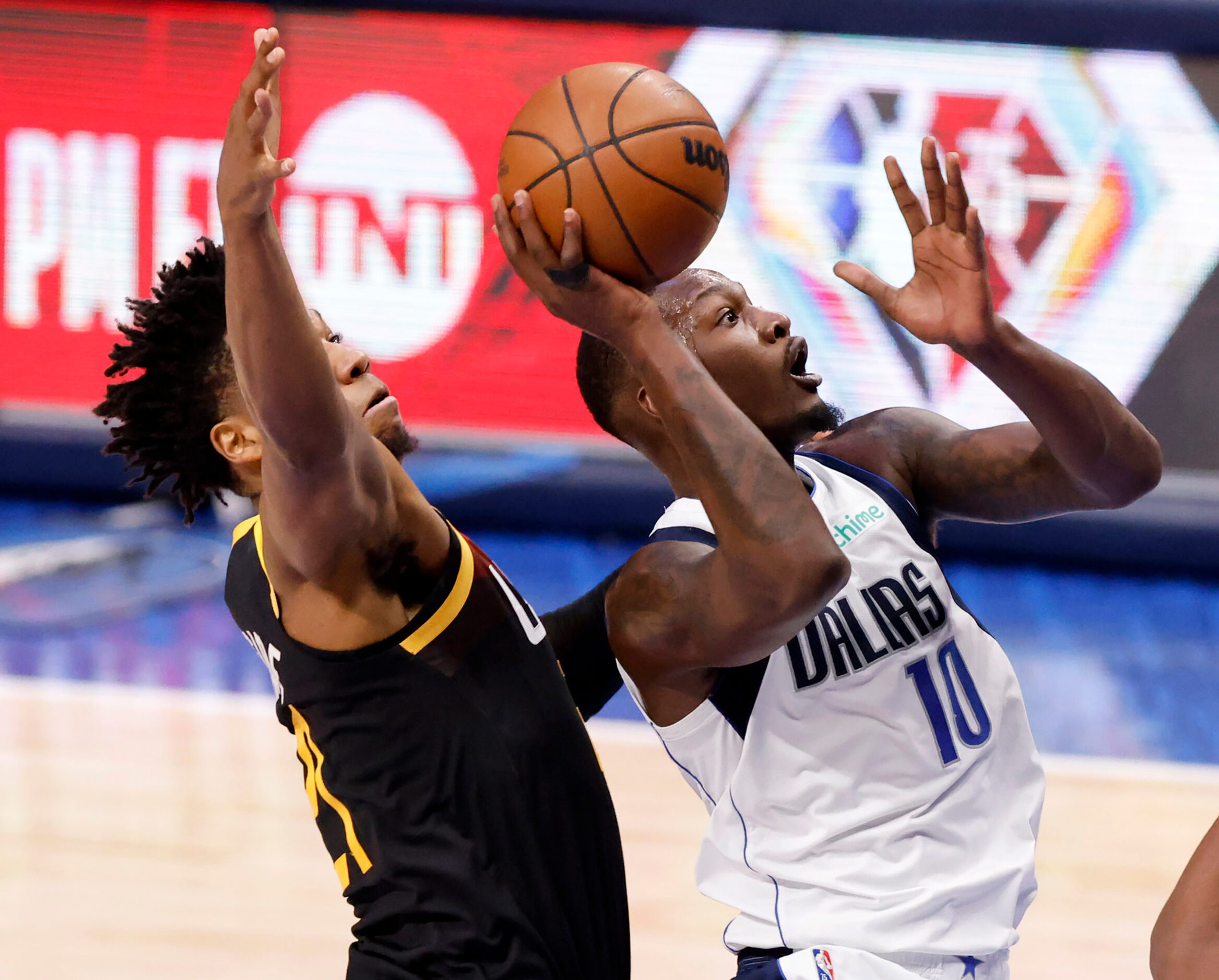 Dallas Mavericks forward Dorian Finney-Smith (10) puts up a first half shot against Utah...