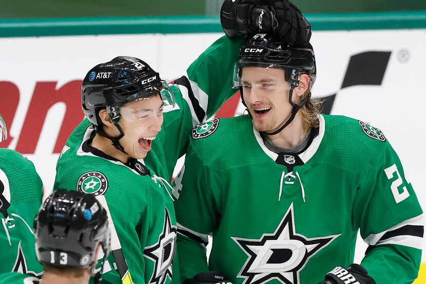 Dallas Stars left wing Jason Robertson (21) congratulates left wing Roope Hintz (right) on...