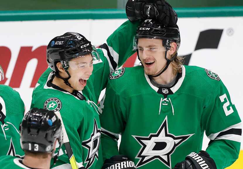 Dallas Stars left wing Jason Robertson (21) congratulates left wing Roope Hintz (right) on...