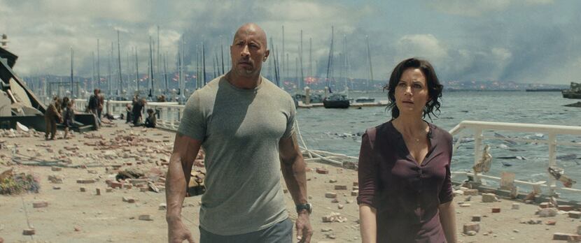 This photo provided by Warner Bros. Pictures shows Dwayne Johnson, left, as Ray, and Carla...