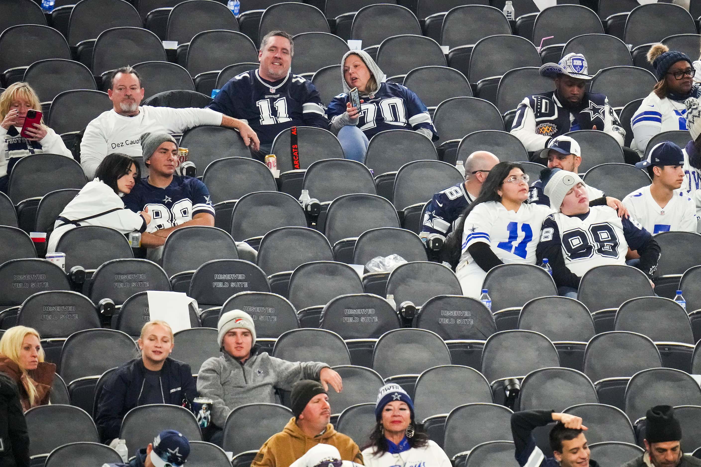 The few remaining Dallas Cowboys fans look on during the fourth quarter of loss to the Green...