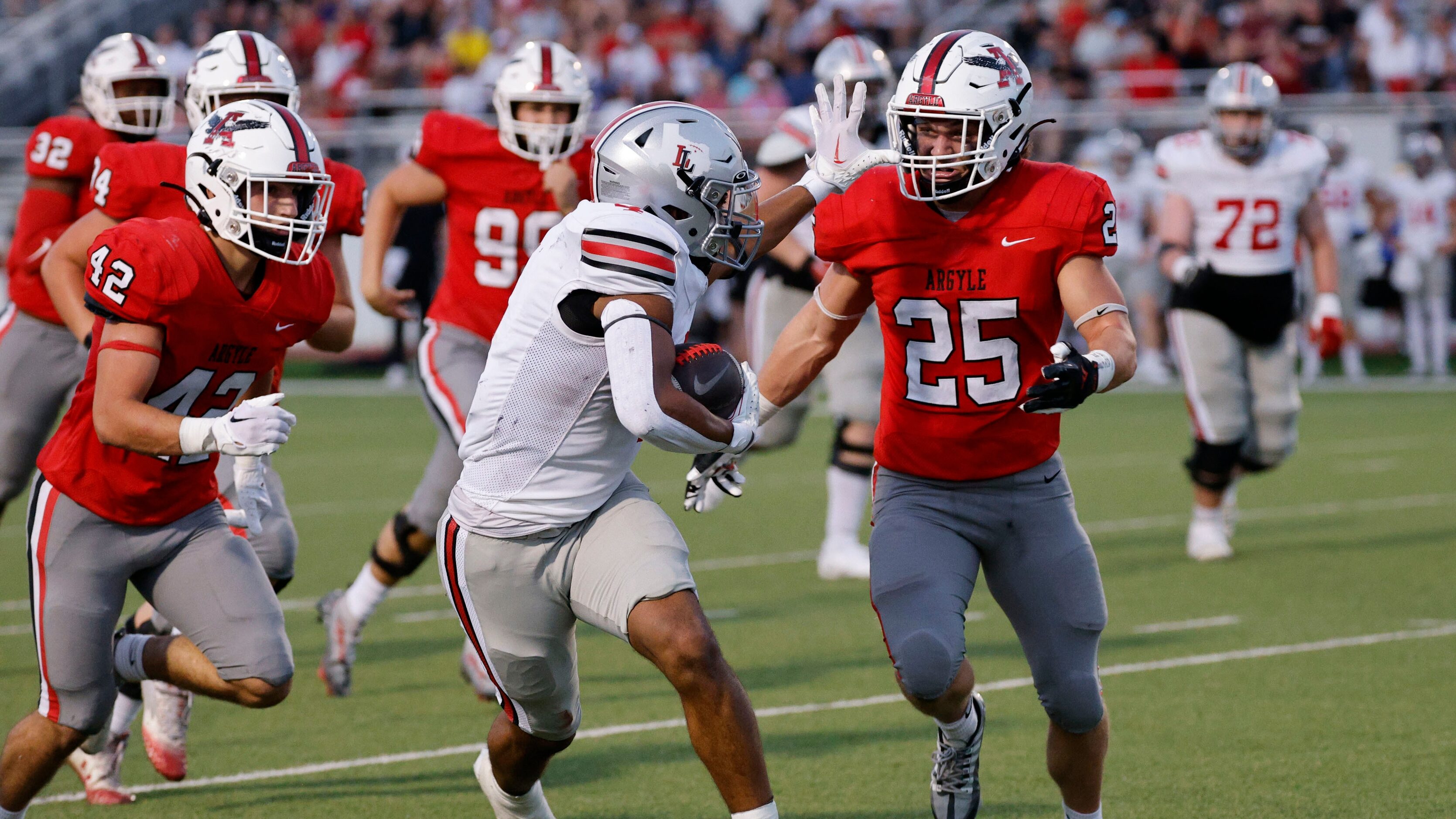 Lovejoy's Dante Dean (4) carries a ball as Argyle's Bud Petter (25) goes to stop him during...