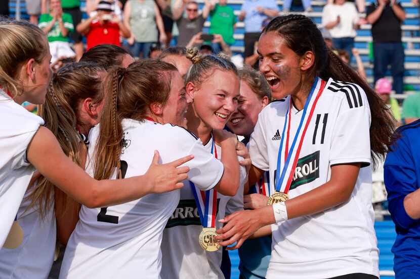 Teammates congratulate Southlake Carroll midfielder Kennedy Fuller (second from right) after...