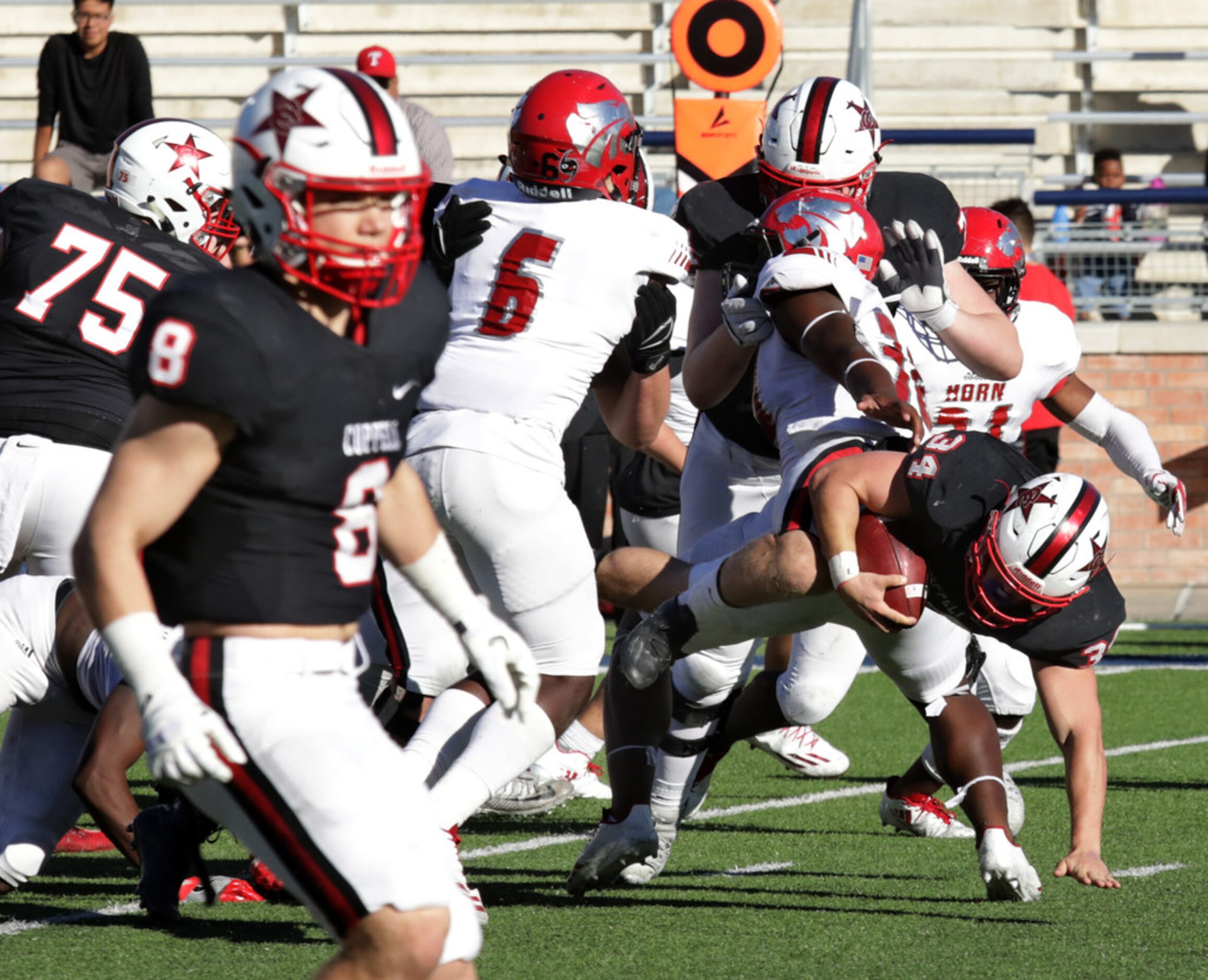 Coppell player 34, Ryan Hirt, breaks through the line during a Class 6A division I playoff...