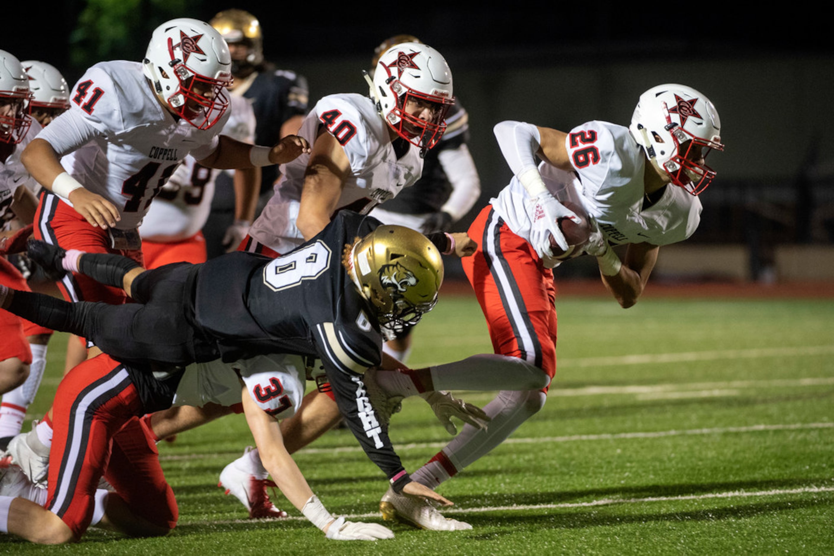 Coppell senior defensive back Noah Snelson (26) recovers a fumble he caused during the...