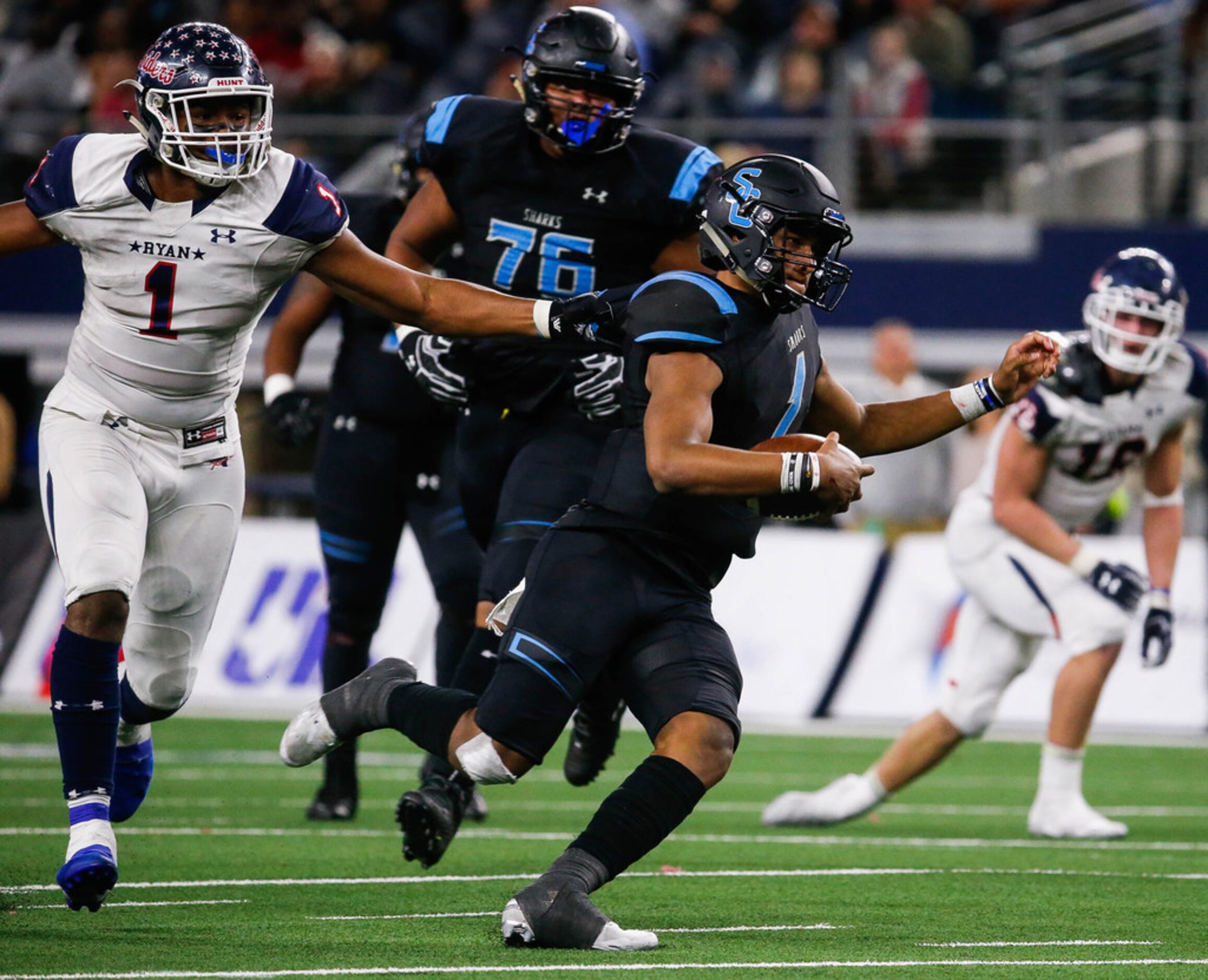 Denton Ryan's Ja'Tavion Sanders (1) holds Alvin Shadow Creek's quarterback Kyron Drones (1)...