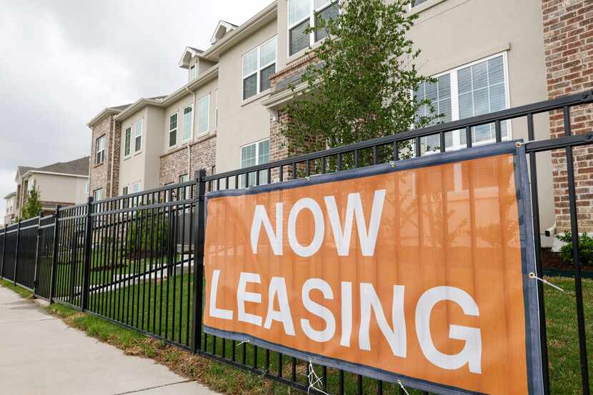 A now leasing sign hangs infront of a model home at the Residences at Rayzor Ranch in Denton...