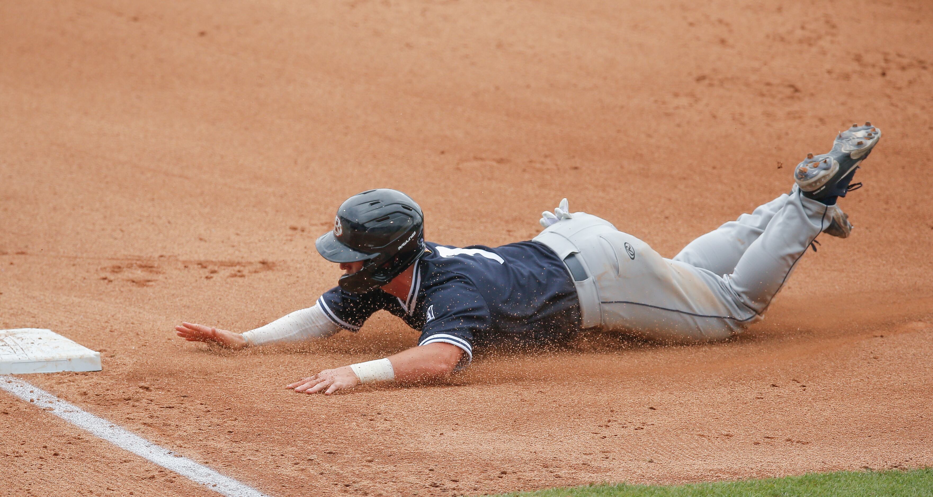 DBU’s Jackson Glenn (3) dives into third in the fourth inning during the NCAA Fort Worth...